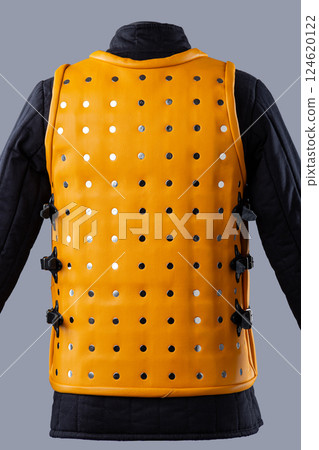 Bright Yellow Brigandine Armor with Studs. This image shows a bright yellow brigandine armor, featuring rows of silver studs and black straps with buckles on the sides. Bright Yellow Brigandine Armor with Studs. This image shows a bright yellow brigandine armor, featuring rows of silver studs and black straps with buckles on the sides. 124620122