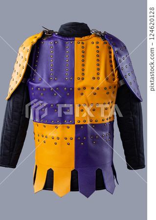 Colorful Brigandine Armor with Studs and Buckles. This image shows a vibrant piece of brigandine armor, featuring a combination of purple and yellow leather sections adorned with studs and secured Colorful Brigandine Armor with Studs and Buckles. This image shows a vibrant piece of brigandine armor, featuring a combination of purple and yellow leather sections adorned with studs and secured 124620128