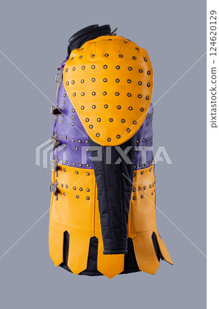 Colorful Brigandine Armor with Studs and Buckles. This image shows a vibrant piece of brigandine armor, featuring a combination of purple and yellow leather sections adorned with studs and secured Colorful Brigandine Armor with Studs and Buckles. This image shows a vibrant piece of brigandine armor, featuring a combination of purple and yellow leather sections adorned with studs and secured 124620129