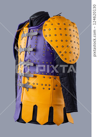 Colorful Brigandine Armor with Studs and Buckles. This image shows a vibrant piece of brigandine armor, featuring a combination of purple and yellow leather sections adorned with studs and secured 124620130