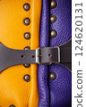 Close-Up of Colorful Brigandine Armor Details. This image provides a detailed close-up of the colorful brigandine armor, showcasing the studs, leather straps with buckles, and the contrasting purple Close-Up of Colorful Brigandine Armor Details. This image provides a detailed close-up of the colorful brigandine armor, showcasing the studs, leather straps with buckles, and the contrasting purple 124620131