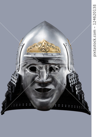 Silver Samurai Helmet with Ornate Gold Details and Fierce Mask. This image showcases a silver samurai helmet with intricate gold decorations on the crown and a detailed face mask with a stern Silver Samurai Helmet with Ornate Gold Details and Fierce Mask. This image showcases a silver samurai helmet with intricate gold decorations on the crown and a detailed face mask with a stern 124620138