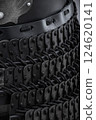 Close-Up of Black Samurai Armor Plates. This image shows a detailed close-up of black samurai armor, featuring numerous small, overlapping plates connected by dark cords. Close-Up of Black Samurai Armor Plates. This image shows a detailed close-up of black samurai armor, featuring numerous small, overlapping plates connected by dark cords. 124620141