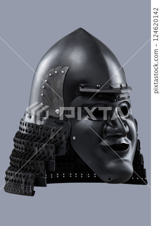 Dark Samurai Helmet with Menacing Face Mask. This image features a dark, almost black, samurai helmet with a detailed face mask displaying a fierce expression. Dark Samurai Helmet with Menacing Face Mask. This image features a dark, almost black, samurai helmet with a detailed face mask displaying a fierce expression. 124620142