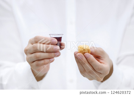 Holy Communion, Christians praying with bread and wine symbolizing the holy blood and body of Jesus Christ, Easter background during Lent 124620372
