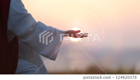 Jesus Christ hand silhouette, evangelism and salvation concept, bright sun and easter background Jesus Christ hand silhouette, evangelism and salvation concept, bright sun and easter background 124620378