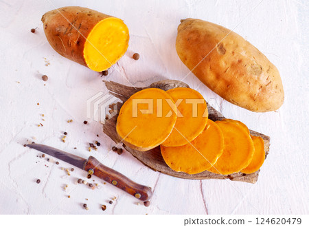 fresh sweet potatoes on a light rustic background. fresh sweet potatoes on a light rustic background. 124620479