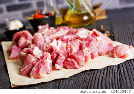 Raw meat with herbs and spices ready for cooking are on wooden table 124620497