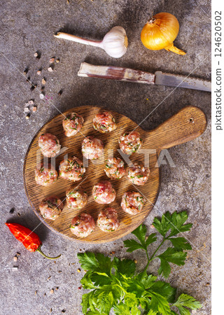 Meatballs from raw minced meat on gray table 124620502