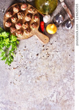 Meatballs from raw minced meat on gray table Meatballs from raw minced meat on gray table 124620505