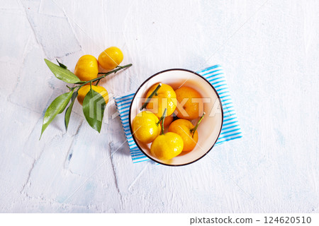 Fresh mandarin oranges fruit or tangerines with leaves on a table 124620510