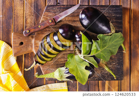 fresh eggplant on wooden cutting board 124620533