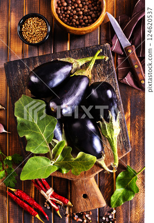 fresh eggplant on wooden cutting board 124620537