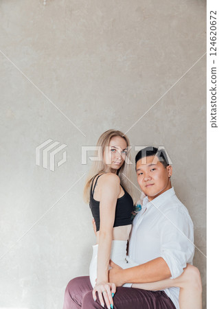 Man And Woman Sitting Together Side By Side Hugging And Smiling 124620672