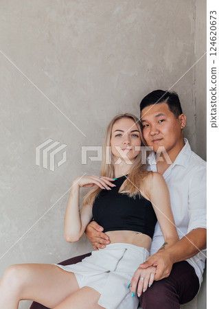 Man And Woman Sitting Together Side By Side Hugging And Smiling 124620673