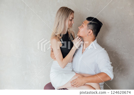 Man And Woman Sitting Side By Side Hugging And Smiling 124620674