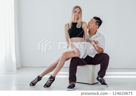 Man And Woman Sitting Side By Side Hugging Smiling 124620675