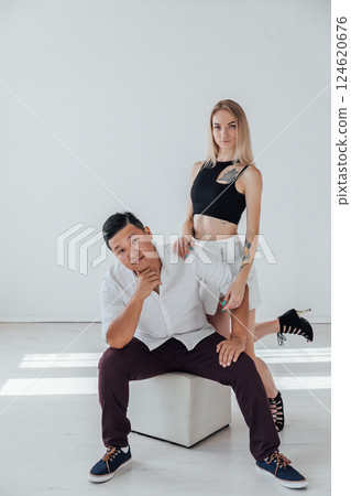 Man And Woman Sitting Side By Side Hugging Smiling 124620676