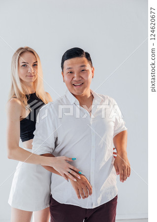 Man and woman standing side by side and hugging 124620677