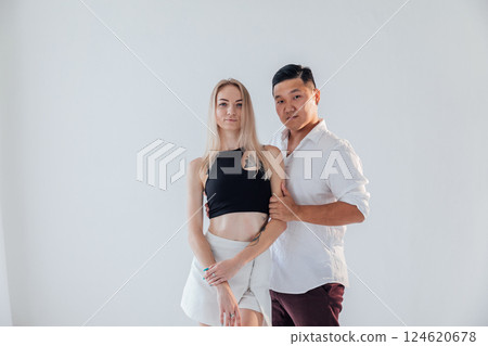 Man and woman standing side by side and hugging 124620678
