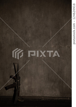 Weapon Assault Rifle Stands Against Dark Wall As Background Weapon Assault Rifle Stands Against Dark Wall As Background 124620918