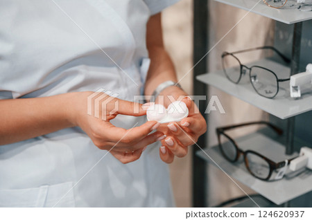 Close up view of woman's hands that holding lenses 124620937