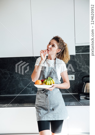 housewife preparing eating fruit in the kitchen for dinner housewife preparing eating fruit in the kitchen for dinner 124620952