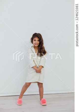 curly girl in a bathrobe and slippers 124621081