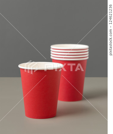 Disposable red paper cups on a gray closeup, mockup. No plastic and sustainable lifestyle 124621236