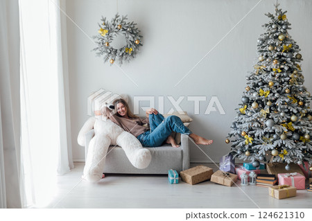 Woman with Bear Toy and Christmas Tree with New Year Gifts Woman with Bear Toy and Christmas Tree with New Year Gifts 124621310