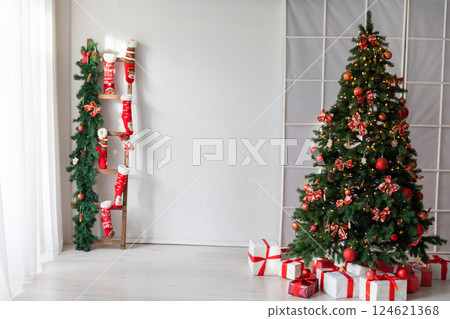 Living room interior with a Christmas tree decorated with gifts for the new year Living room interior with a Christmas tree decorated with gifts for the new year 124621368