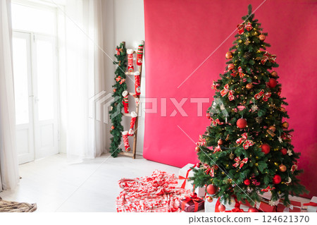 Living room interior with a Christmas tree decorated with gifts for the new year Living room interior with a Christmas tree decorated with gifts for the new year 124621370