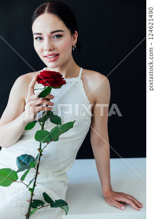Beautiful Woman Brunette Bride in White Dress With Red Rose 124621490