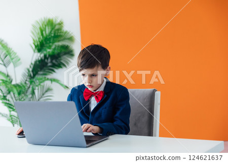 Schoolboy Boy In Business Suit Working On Laptop Online Schoolboy Boy In Business Suit Working On Laptop Online 124621637
