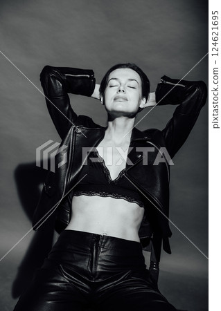 Portrait of a beautiful slender woman 40 years old sitting on an armchair 124621695