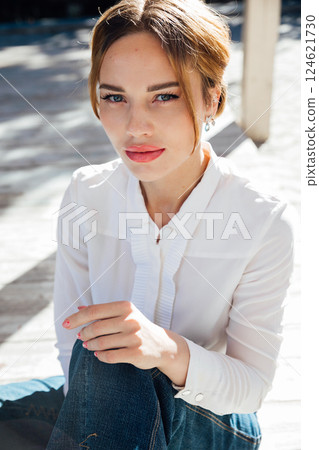 Portrait of a beautiful slender fashion woman in a blouse and skirt on a street walk 124621730