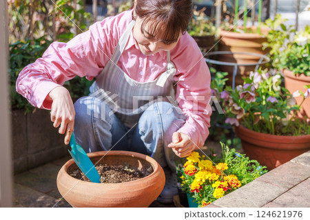 Woman planting flowers Gardening 124621976