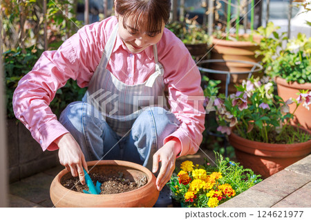 Woman planting flowers Gardening 124621977