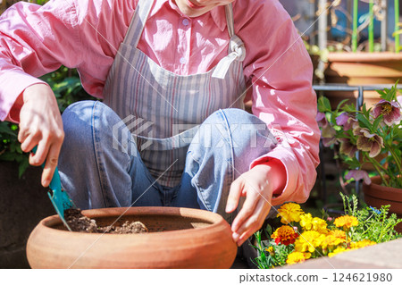 Woman planting flowers Gardening 124621980
