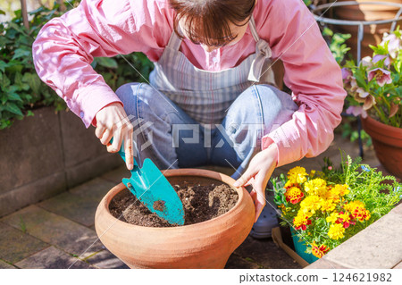 Woman planting flowers Gardening 124621982
