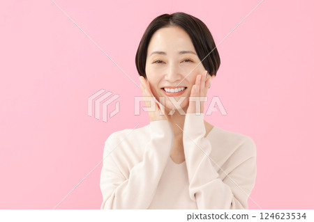 Smiling middle-aged woman with colored bag Smiling middle-aged woman with colored bag 124623534