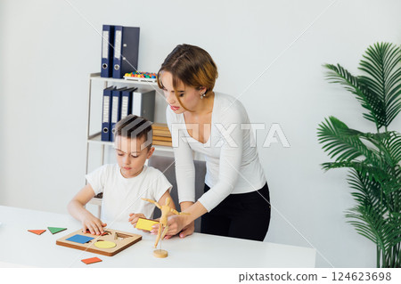 Female teacher and developmental training sessions with a boy Female teacher and developmental training sessions with a boy 124623698