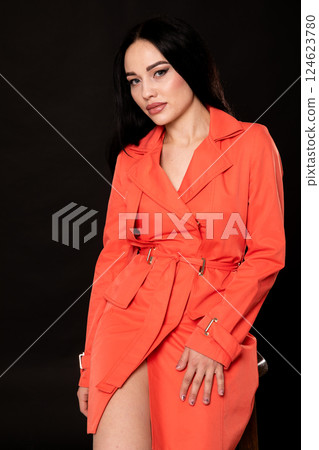 Portrait of a beautiful fashionable woman in a red autumn dress Portrait of a beautiful fashionable woman in a red autumn dress 124623780