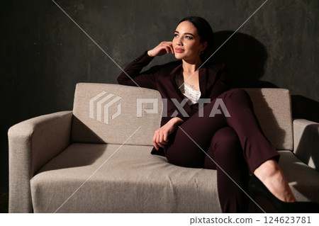 Portrait of a beautiful fashionable woman in a business suit in an office Portrait of a beautiful fashionable woman in a business suit in an office 124623781