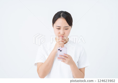Young nurse using smartphone 124623902