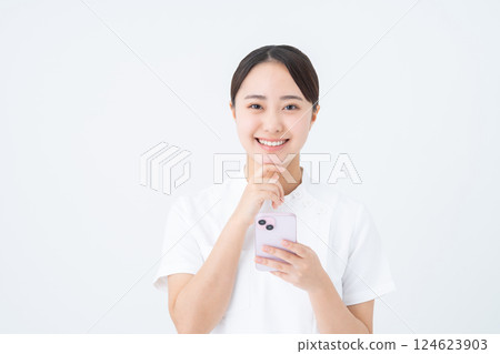 Young nurse using smartphone 124623903