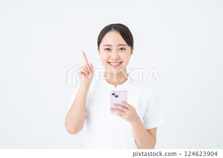 Young nurse using smartphone Young nurse using smartphone 124623904