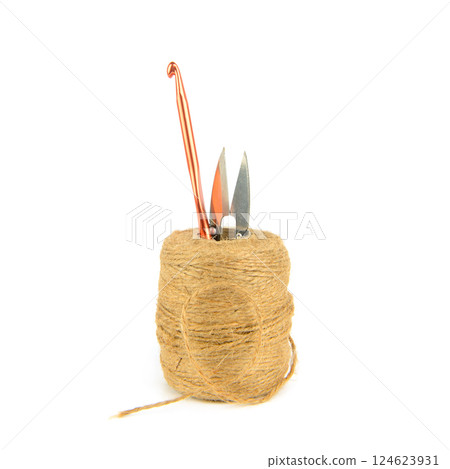 Roll of hemp rope, crochet hook and scissors isolated on white background. 124623931