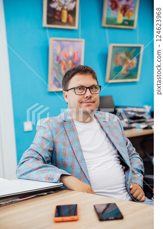 Business man working online learning on laptop at desk in office 124623968