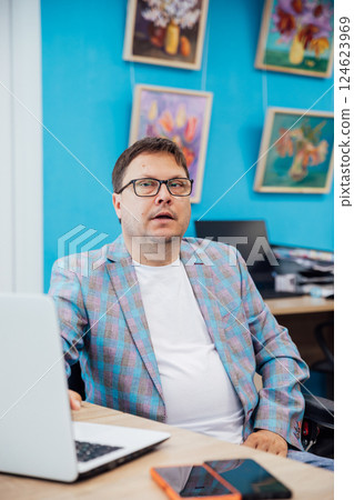 Business man working online learning on laptop at desk in office Business man working online learning on laptop at desk in office 124623969